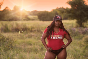 Tonya wearing her husband's favorite sports team for her outdoor boudoir session.