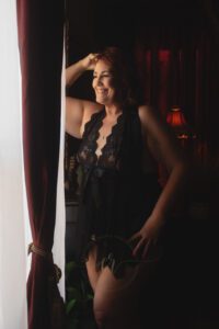 63-year-old boudoir client Pam seeing her images during the reveal at Christine Roberts Photography in Talco, Texas.